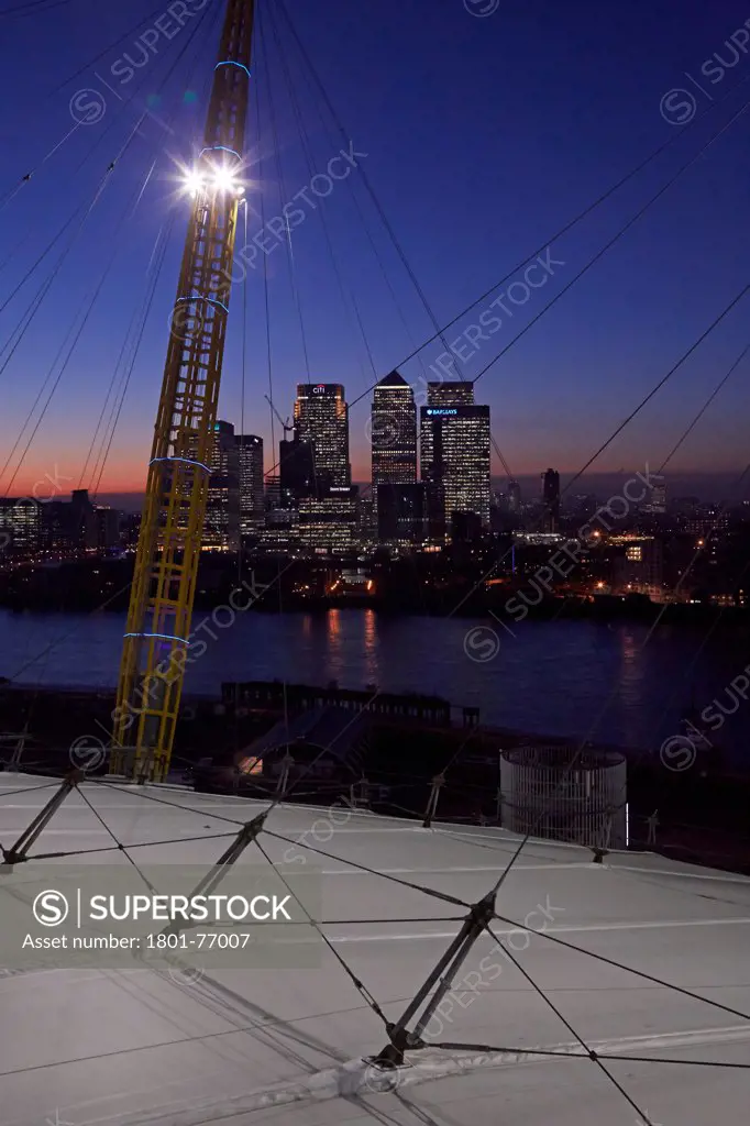 'Up at the O2'- High level walkway over the Millenium Dome, London, United Kingdom. Architect: Rogers Stirk Harbour + Partners, 2012. Dusk view looking towards Canary Wharf.