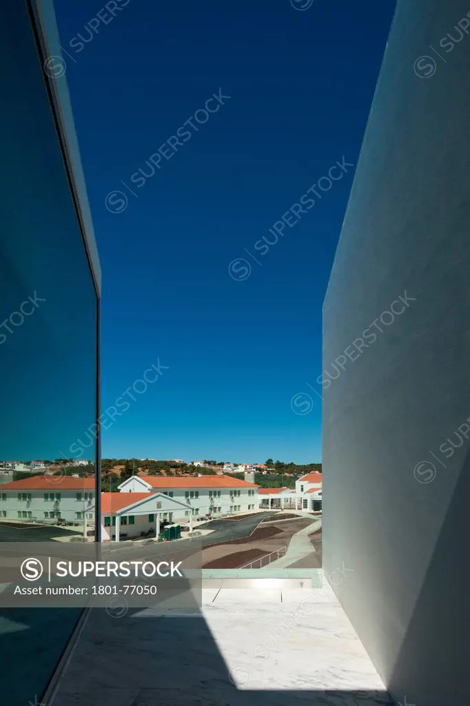 House for Elderly People, Alcaçer do Sal, Portugal. Architect: Francisco Aires Mateus Arquitectos, 2011. View from social housing complex in daylight to town.