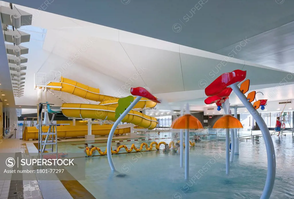 Centre Aquatique, St Hyacinthe, St Hyacinthe, Canada. Architect: Architecture, 2012. View of leisure pool showing water features and water slides.