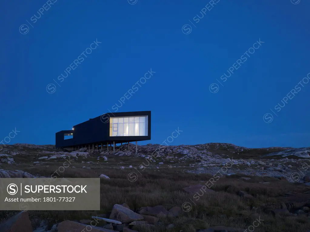 Long Studio, Fogo Island, Canada. Architect: Todd Saunders, 2011. Night-time view from beach.