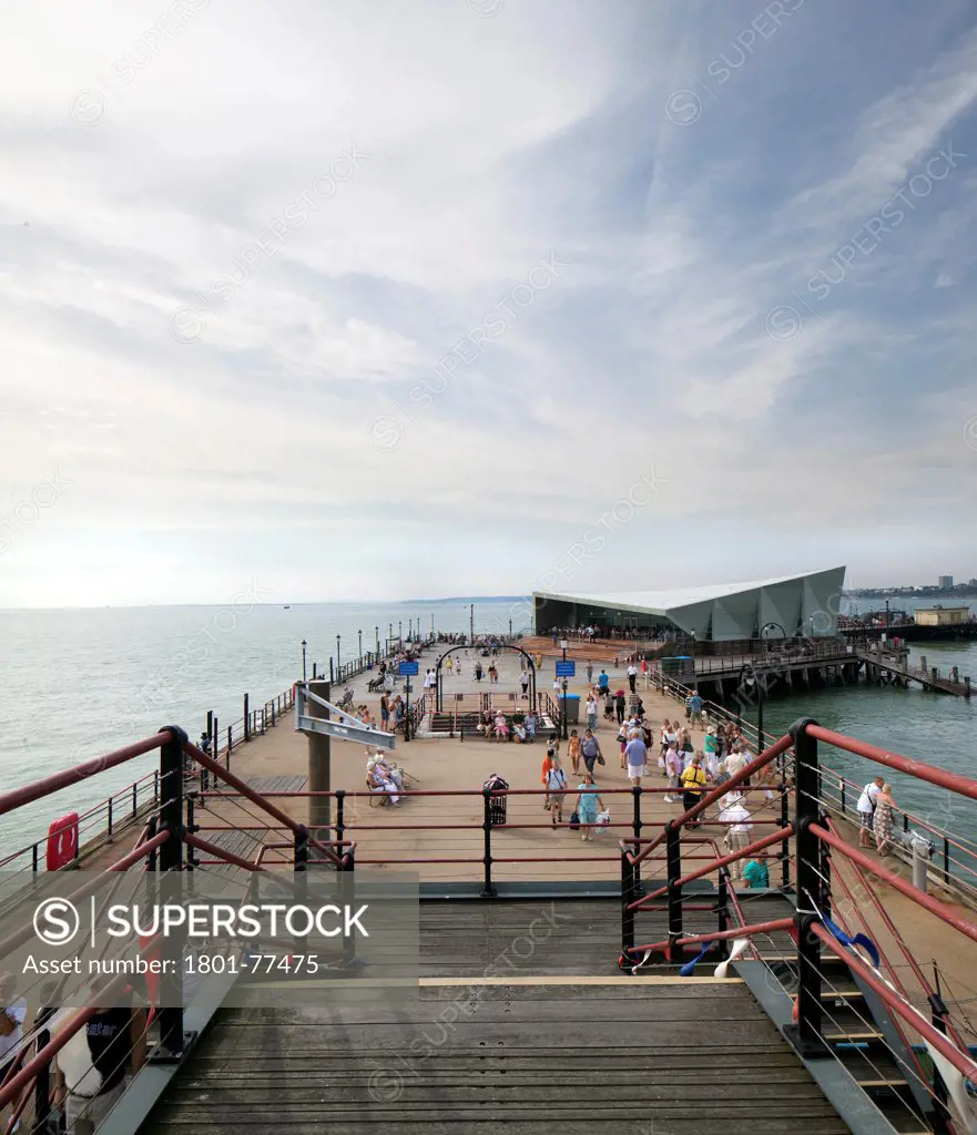 Southend Pier Cultural Centre, Southend, United Kingdom. Architect: White Architects, 2012. Main exterior with people taken from the lifeboat station.