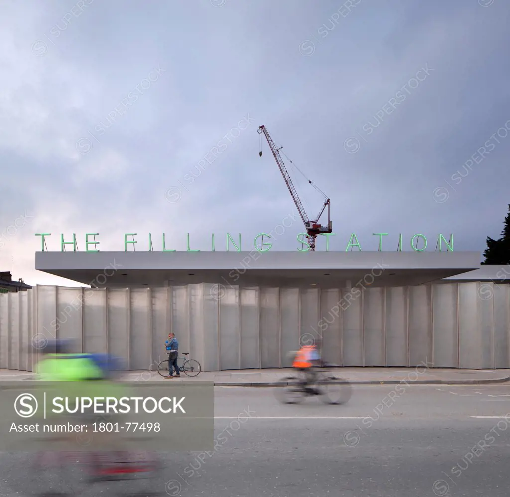 The Filling Station, London, United Kingdom. Architect: Carmody Groarke, 2012. Front view with cyclists.