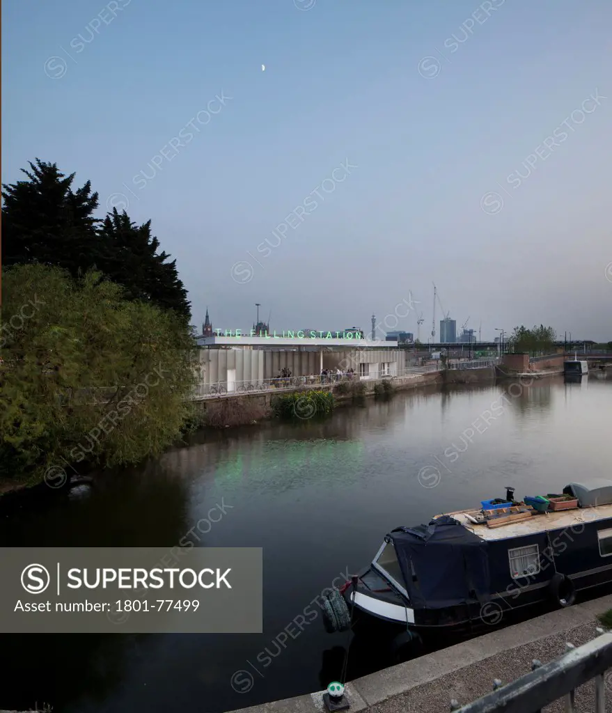 The Filling Station, London, United Kingdom. Architect: Carmody Groarke, 2012. Early evening view across the canal. With a barge in the foreground.