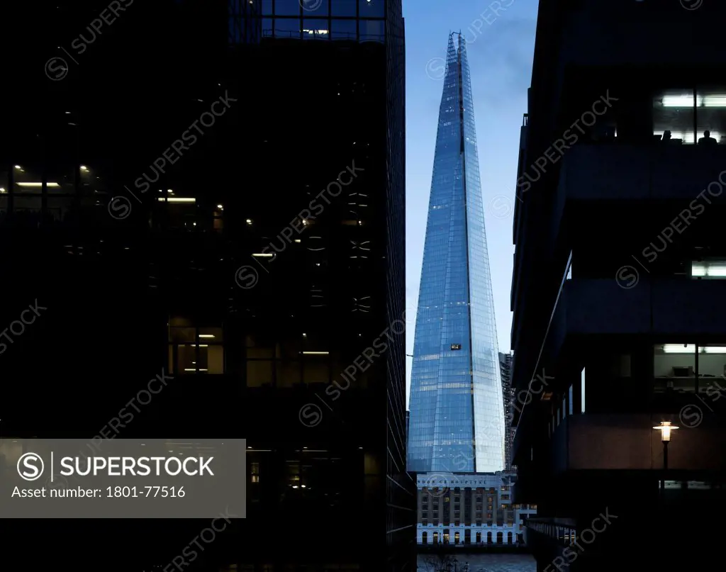 The Shard, London, United Kingdom. Architect: RENZO PIANO , 2012. Square view framed by offices from north bank of thames at dusk.