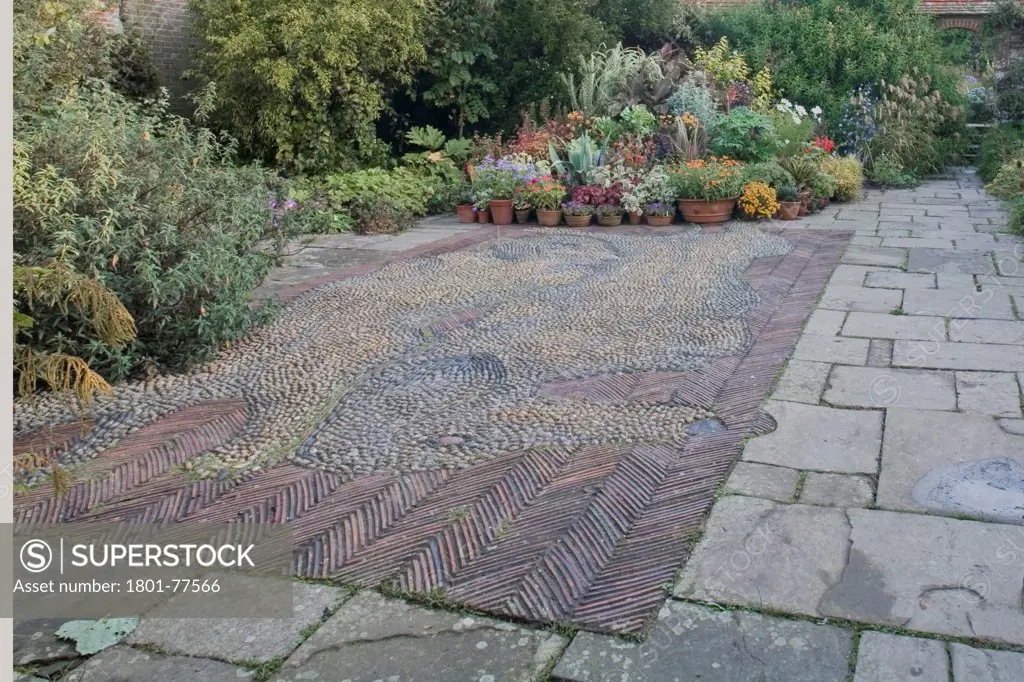 Great Dixter House & Garden, Northiam, United Kingdom. Architect: Edwin Lutyens, 1912. Walled garden with stone mosaic.