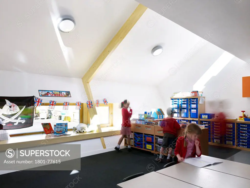 Dulwich Village Infant School, London, United Kingdom. Architect: Cazenove Architects, 2012. Extension interior classroom, school children studying.