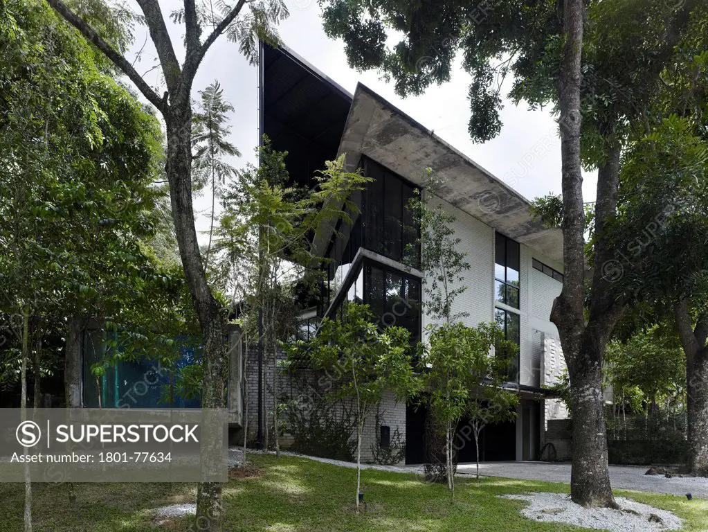 Dog Concrete House, Kuala Lumpur, Malaysia. Architect: Kevin Low, 2012. Main elevation with view into swimming pool.