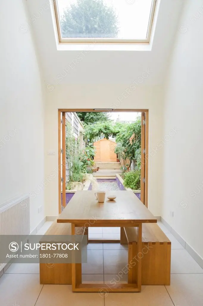 The Slim House, Terraced House, Europe, United Kingdom, , 2012, alma-nac architects. Interior view of dining area looking into garden.