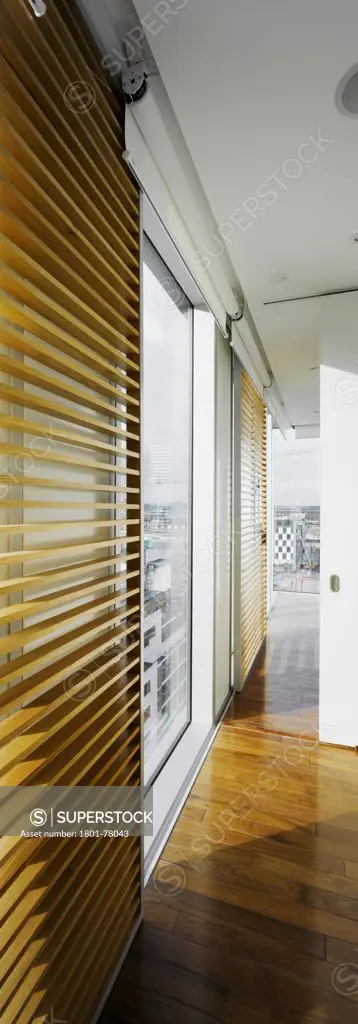 Altro Vetro, Tower Block Flats, Europe, Ireland, Dublin, 2008, Shay Cleary Architects. View of circulation space in apartment showing timber floors and timber adjustable screens open showing view through window.