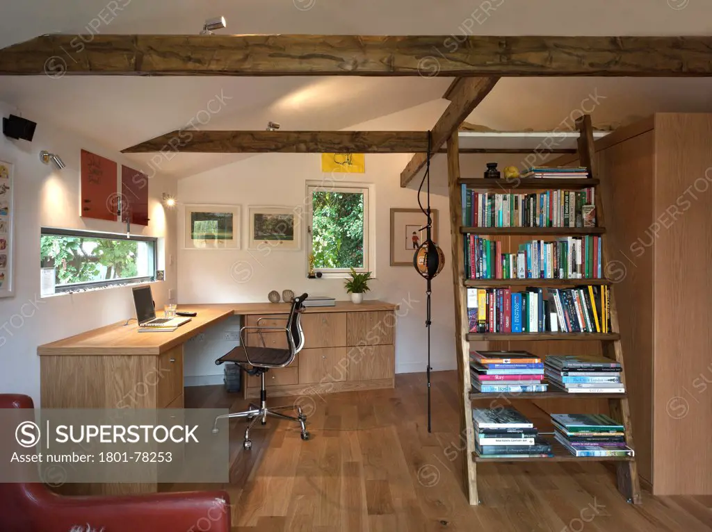 Garden Office, Berkhamsted, United Kingdom. Architect: SDP Design, 2012. Interior room view showing office desk, chair, bookcase, ladder and oak timber flooring.