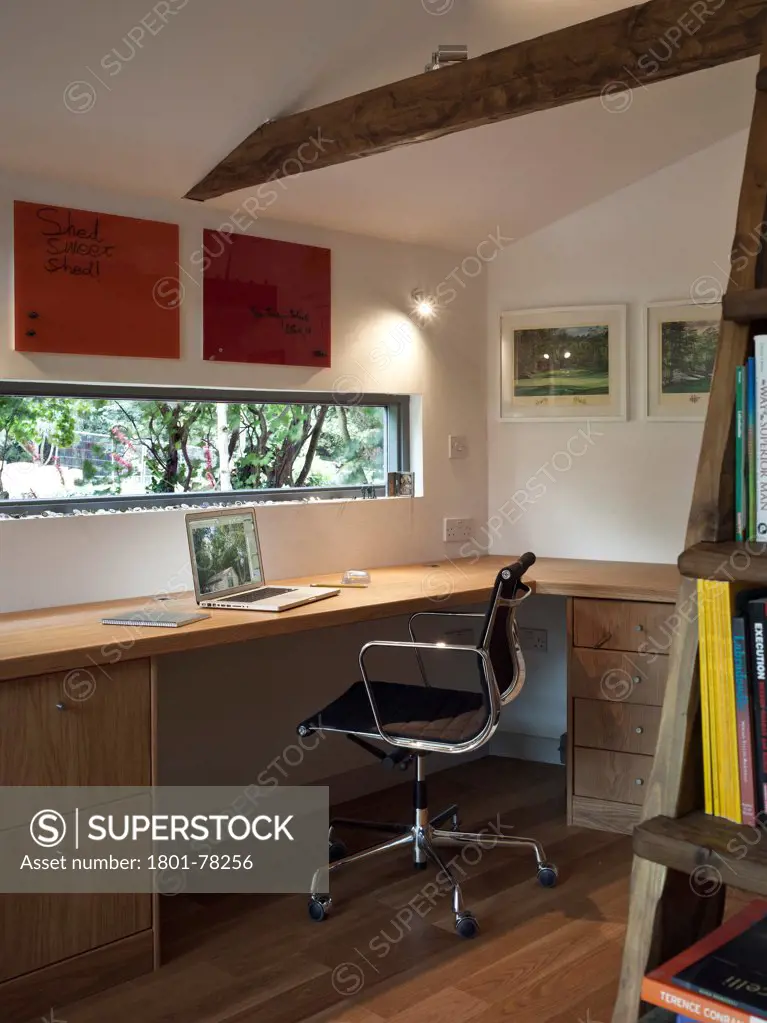 Garden Office, Berkhamsted, United Kingdom. Architect: SDP Design, 2012. Interior room detail showing office desk, chair and window looking out into the garden with timber flooring to the foreground.