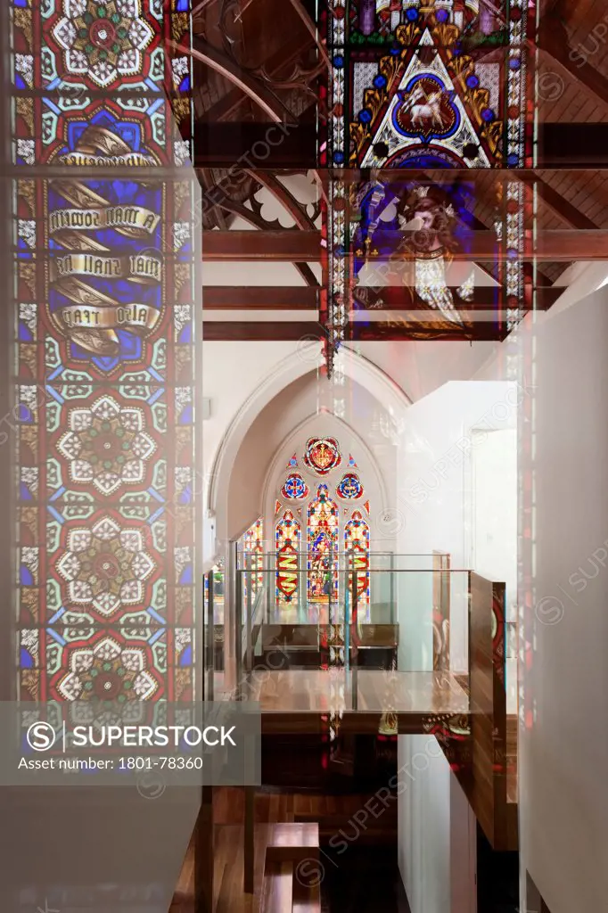 John Knox Church Conversion, Melbourne, Australia. Architect: Williams Boag Architects, 2010. Suspended walkway and stained glass window.