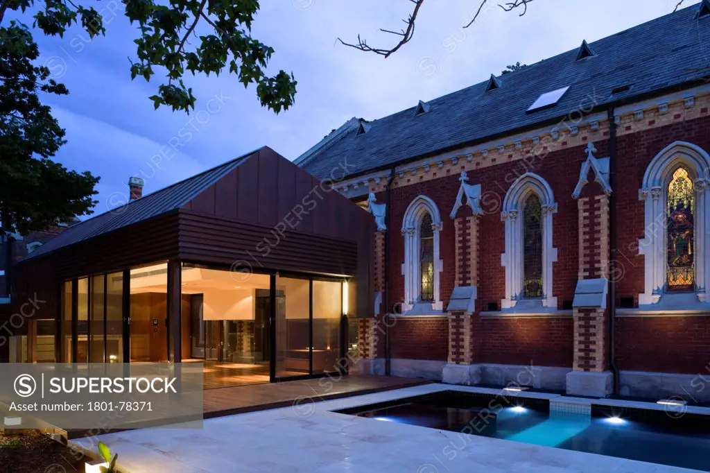 John Knox Church Conversion, Melbourne, Australia. Architect: Williams Boag Architects, 2010. Rear facade showing new extension, original church and swimming pool.