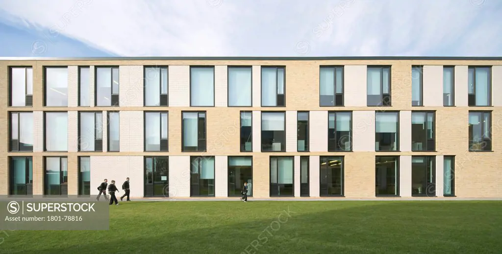 Thomas Tallis School, Greenwich, United Kingdom. Architect: John Mcaslan & Partners, 2012. Panorama Of Three-Storey, Brick Clad Facade With Window Line Up.