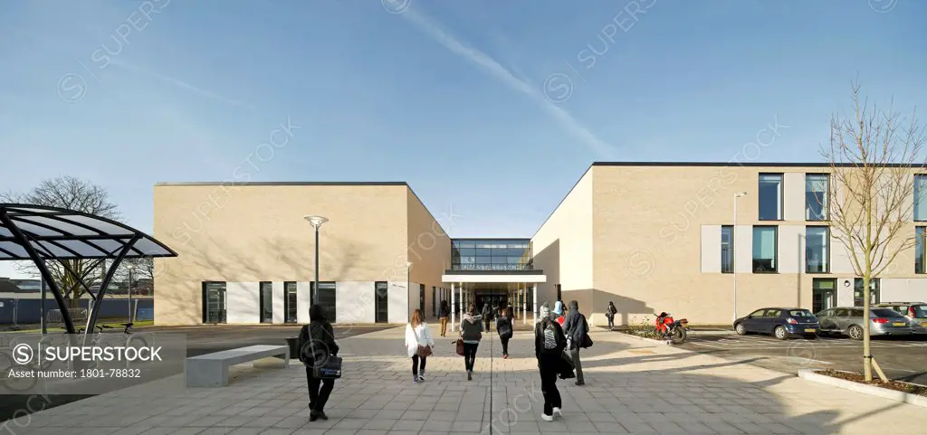 Thomas Tallis School, Greenwich, United Kingdom. Architect: John Mcaslan & Partners, 2012. Front Elevation Of School Entrance With Signage And Car Park.
