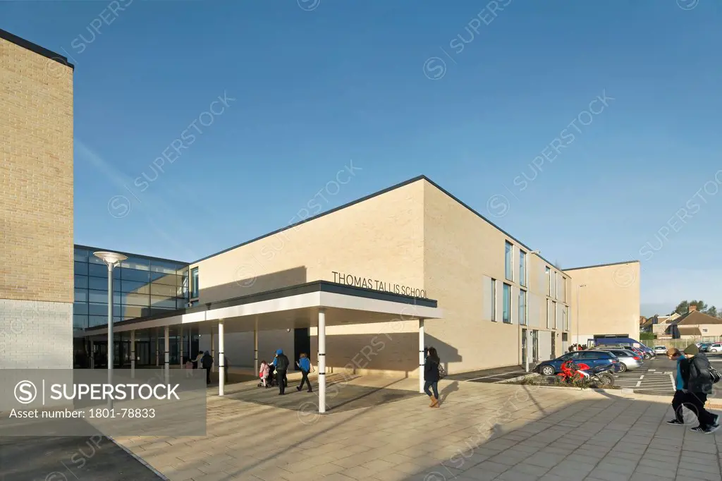 Thomas Tallis School, Greenwich, United Kingdom. Architect: John Mcaslan & Partners, 2012. Corner Elevation Of School Entrance With Signage And Car Park.
