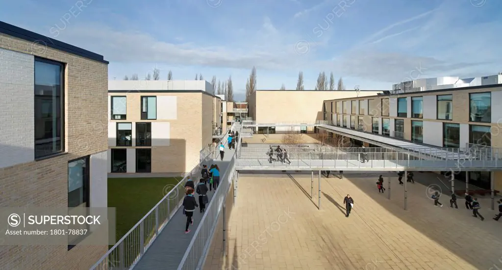 Thomas Tallis School, Greenwich, United Kingdom. Architect: John Mcaslan & Partners, 2012. Central Concourse View With Linking Bridges And Circulating Students.