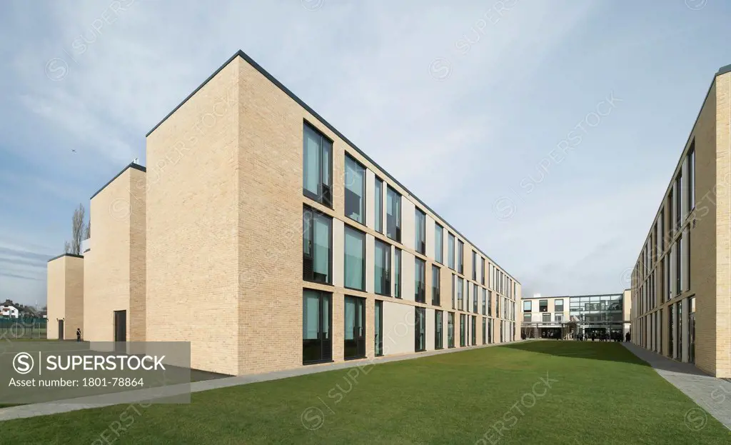 Thomas Tallis School, Greenwich, United Kingdom. Architect: John Mcaslan & Partners, 2012. Oblique View Of Three-Storey, Brick Clad Facade With Window Line Up.