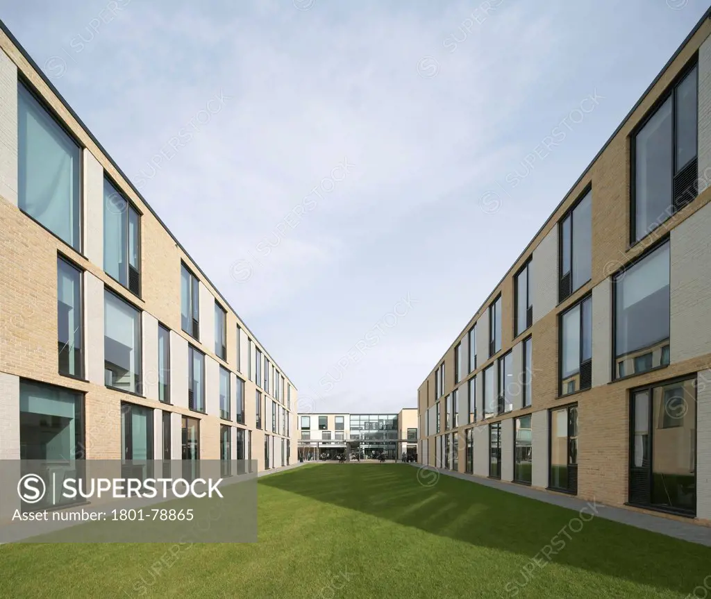 Thomas Tallis School, Greenwich, United Kingdom. Architect: John Mcaslan & Partners, 2012. Three-Storey, Brick Clad Facade With Window Line Up And Green.