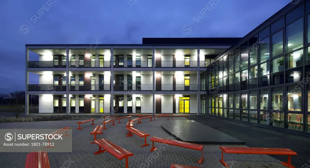 Rsa Academy, Tipton, United Kingdom. Architect: John Mcaslan & Partners, 2011. Schoolyard And Illuminated Building Facades At Dusk.