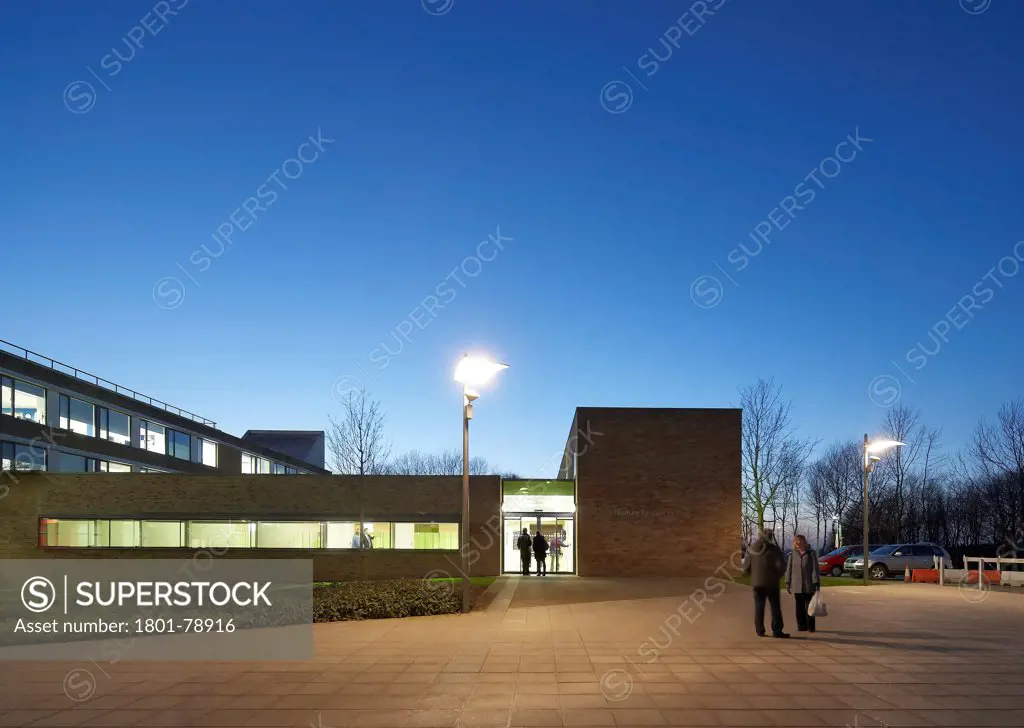 Lancaster University Human Resources Centre, Lancaster, United Kingdom. Architect: John Mcaslan & Partners, 2012. Centre'S Entrance At Dusk.