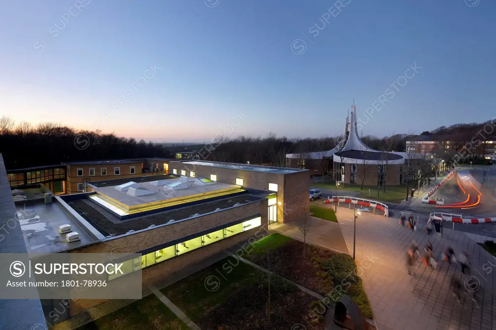 Lancaster University Human Resources Centre, Lancaster, United Kingdom. Architect: John Mcaslan & Partners, 2012. Elevated View Across Campus Roofscape At Dusk.