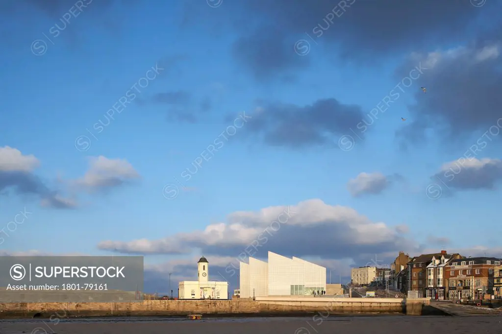 Turner Contemporary Gallery, Margate, United Kingdom. Architect: David Chipperfield Architects Ltd, 2011. Distant View Across Harbour With Dramatic Sky.