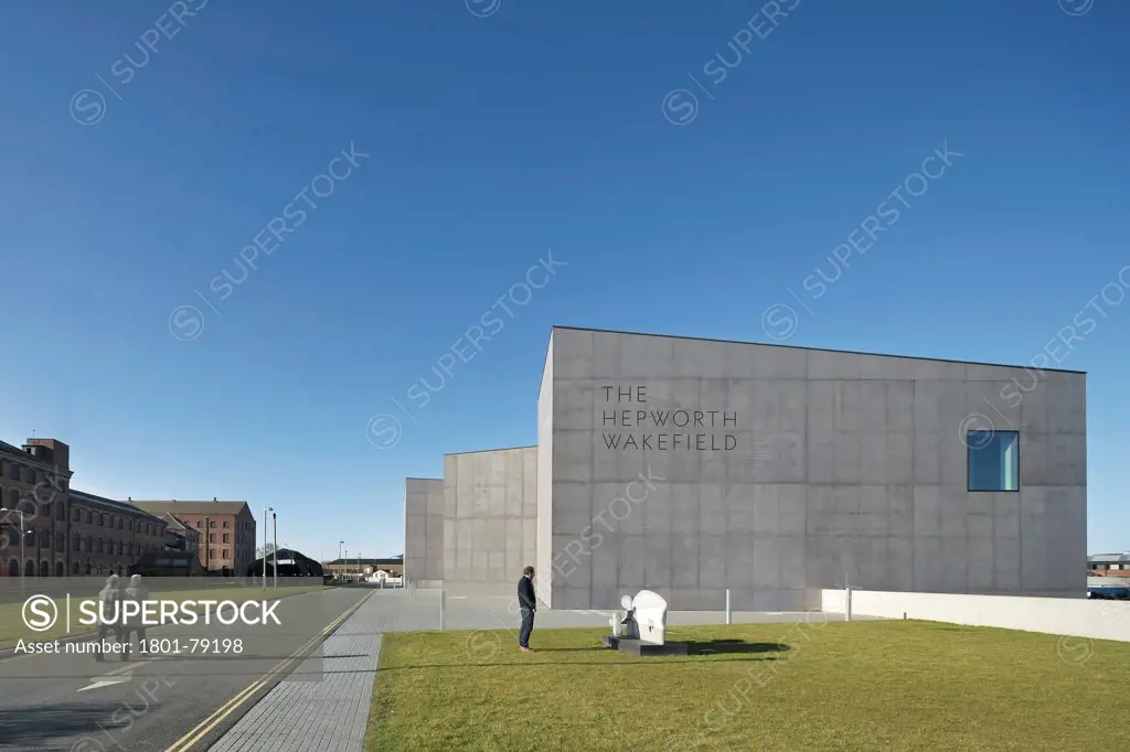 The Hepworth Wakefield, Margate, United Kingdom. Architect: David Chipperfield Architects Ltd, 2011. Sunlit Street View And Trapezoidal Concrete Facade.