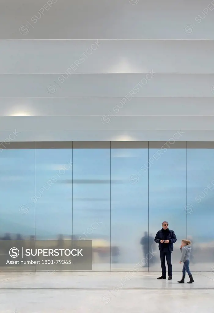 Musée Du Louvre  Lens, Lens, France. Architect: Sanaa, 2012. Two Visitors In Front Of Reflective Aluminium Wall.
