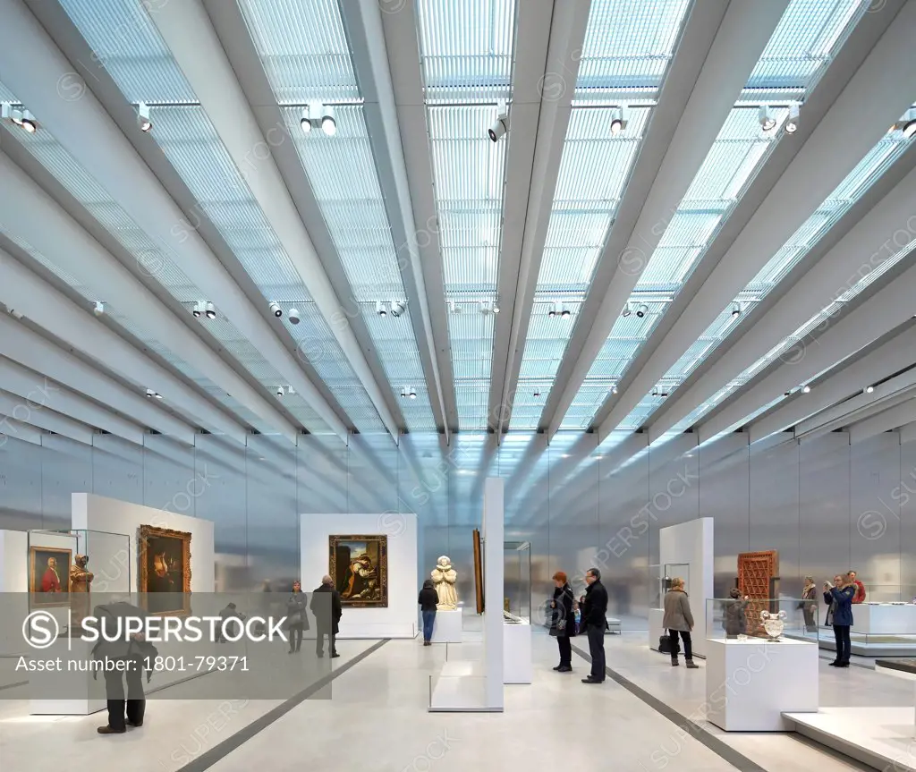 Musée Du Louvre  Lens, Lens, France. Architect: Sanaa, 2012. The Permanent Collection Hall With Glazed Roof Panels, Reflective Wall And Art On Display.