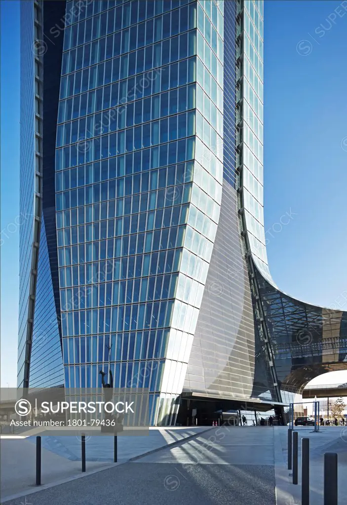 Cma/Cgm Office Tower, Marseille, France. Architect: Zaha Hadid Architects, 2011. South-West Elevation Of Tower'S Base With Forecourt And Curving Glass Bridge.