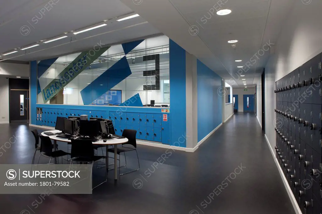 Sidney Stringer Academy, Coventry, Coventry, United Kingdom. Architect: Sheppard Robson , 2012. Corridor With It Work Desk And Glazed Classroom.