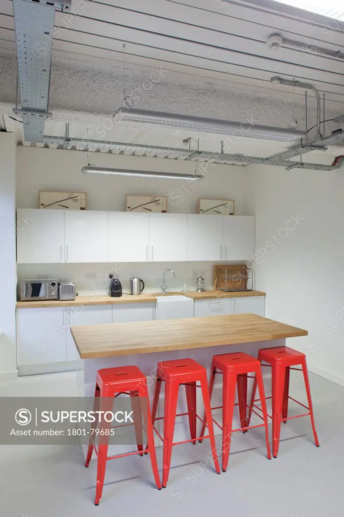 Soundtree Recording Studios, London, United Kingdom. Architect: Ben Adams Architects, 2011. Bar Counter And Red Stools In Studio Kitchen.