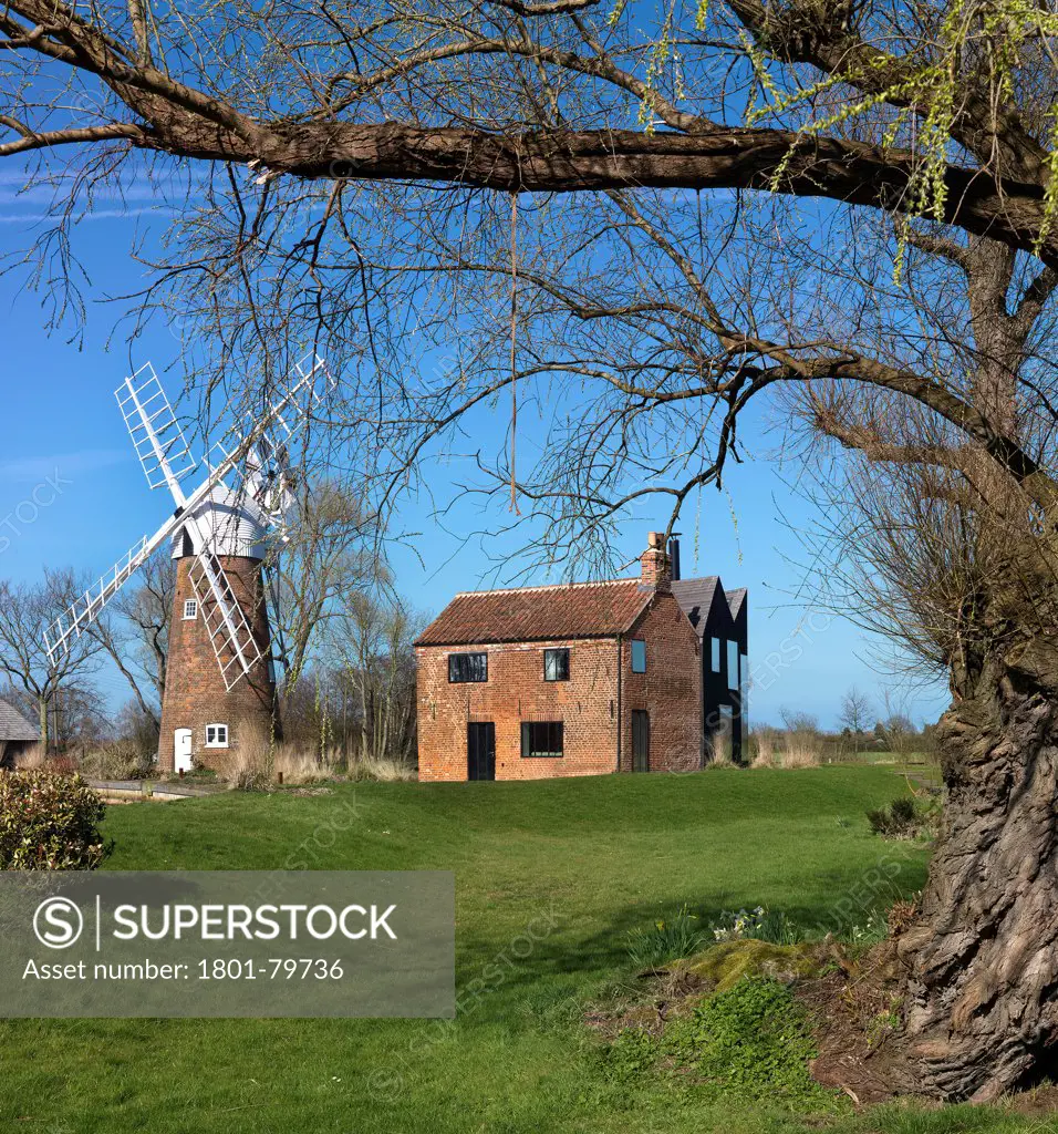 Hunsett Mill, Stalham, United Kingdom. Architect: Acme, 2010. River View With Tree And Windmill.
