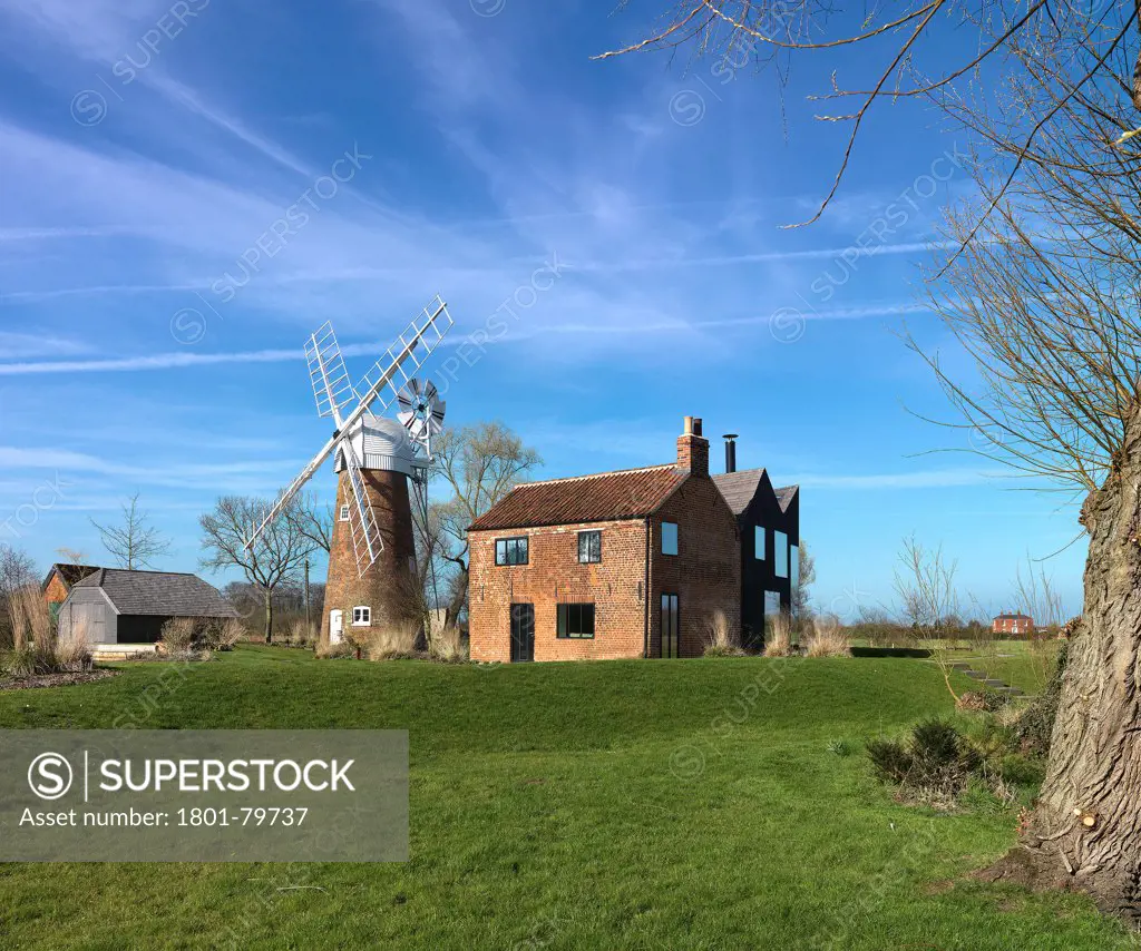 Hunsett Mill, Stalham, United Kingdom. Architect: Acme, 2010. River View With Tree And Windmill.