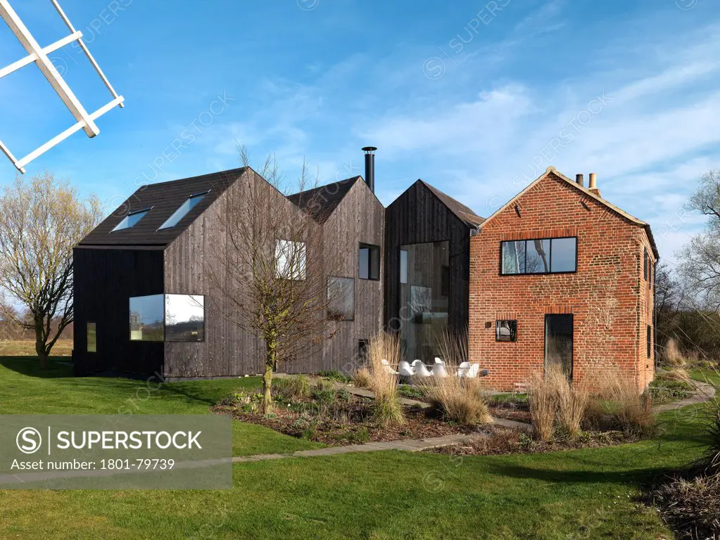 Hunsett Mill, Stalham, United Kingdom. Architect: Acme, 2010. Garden View With Windmill Blade.