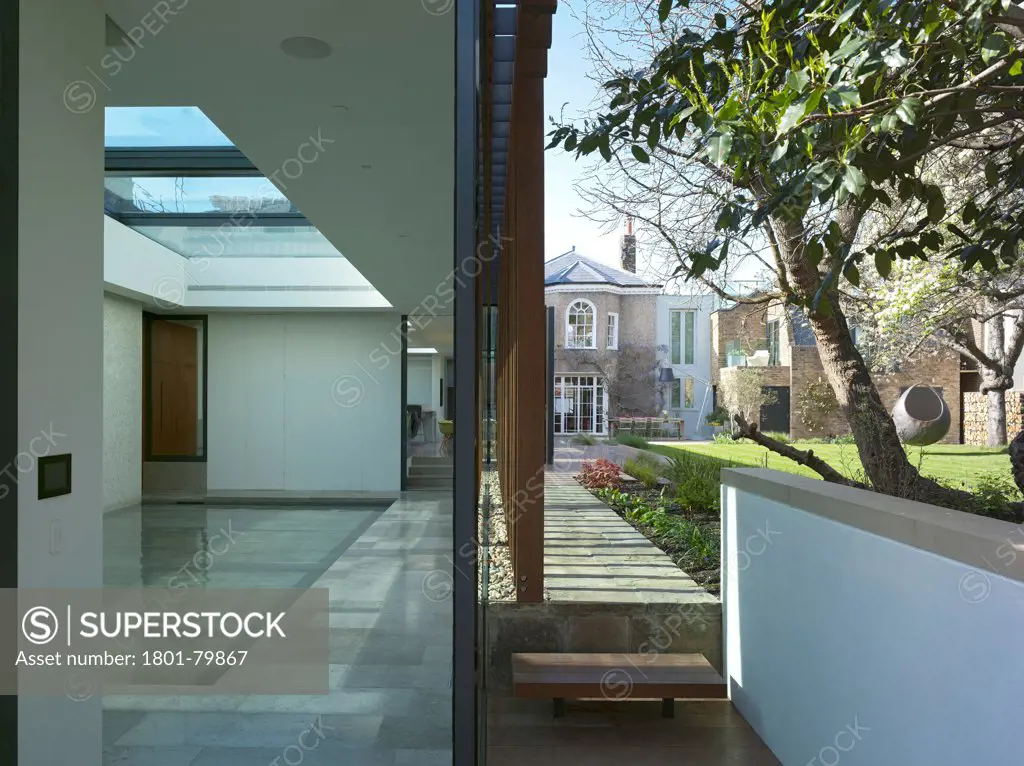 Private House, London, United Kingdom. Architect: Alan Higgs Architects, 2012. Pool Room And Exterior View To Garden With Pool Floor Partly Raised.