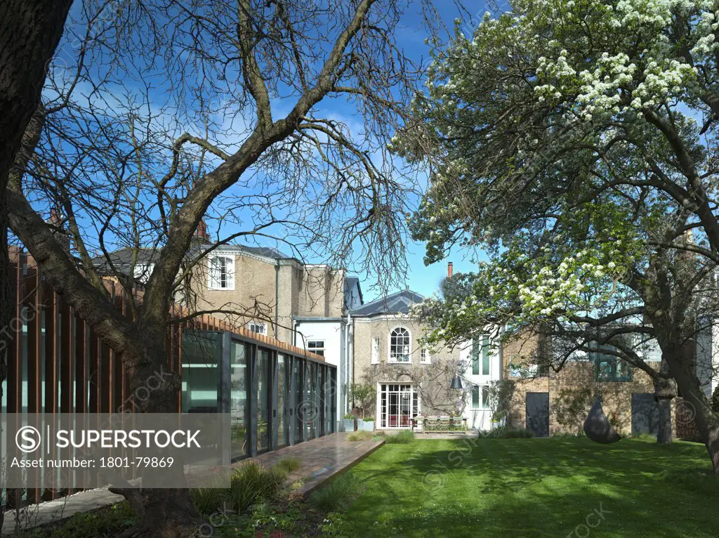 Private House, London, United Kingdom. Architect: Alan Higgs Architects, 2012. Context View From Garden With Old House.