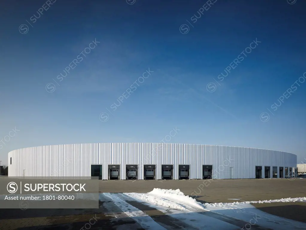 Logistics Building At Vitra Campus, Weil Am Rhein, Germany. Architect: Sanaa, 2012. Oval Logistics Building With Loading Docks In Winterly Conditions.