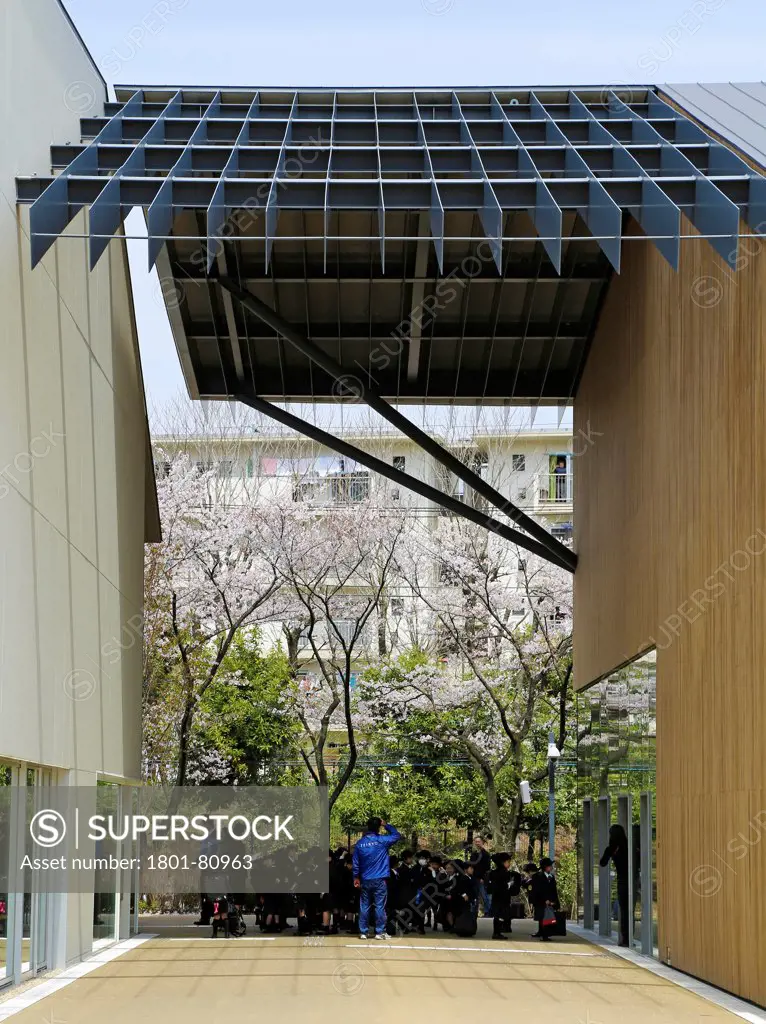 Teikyo University Elementary School, Tokyo, Japan. Architect: Kengo Kuma, 2012. View Towards Entrance With Students.
