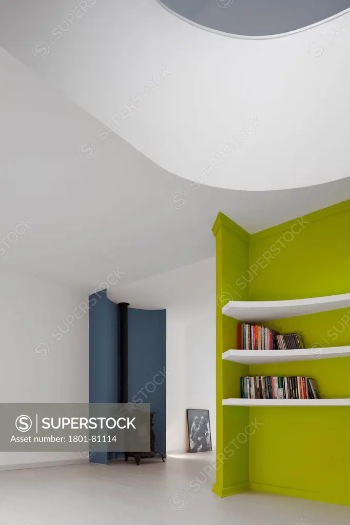 Casa Em Almada, Almada, Portugal. Architect: Pedro Gadanho, 2012. Living Area View With Lime Coloured Bookshelf And Wood Stove.