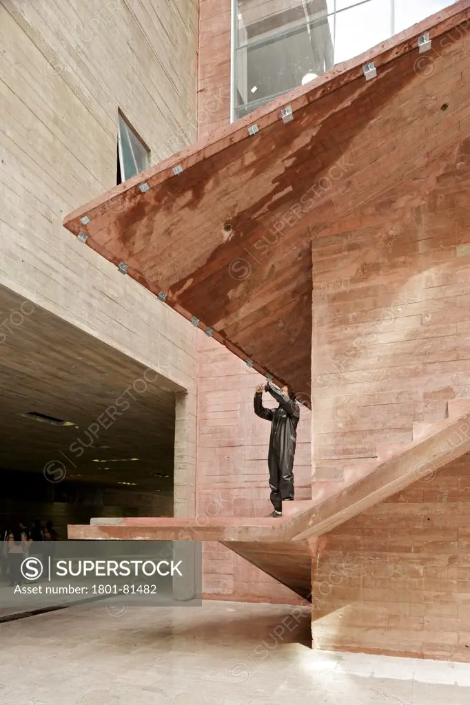Praca Das Artes, Sao Paulo, Brazil. Architect: Brasil Arquitectura, 2012. A Man Standing In The Stairway Takes A Picture During The Opening Day.