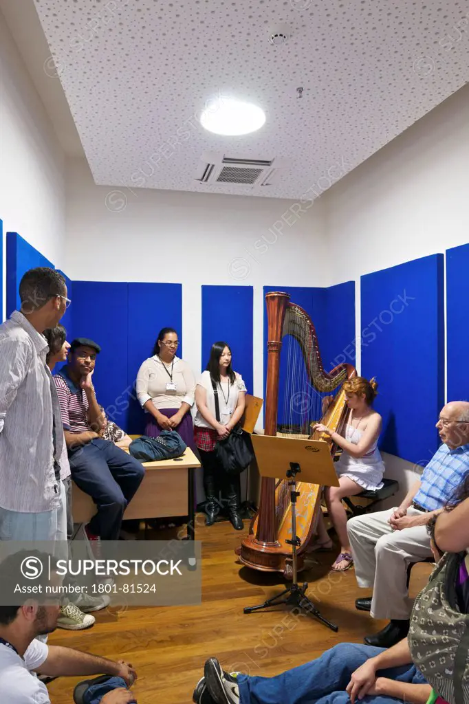 Praca Das Artes, Sao Paulo, Brazil. Architect: Brasil Arquitectura, 2012. Rehearsal Room: A Girl Playing  The Harp While Students And Tutor Listen.