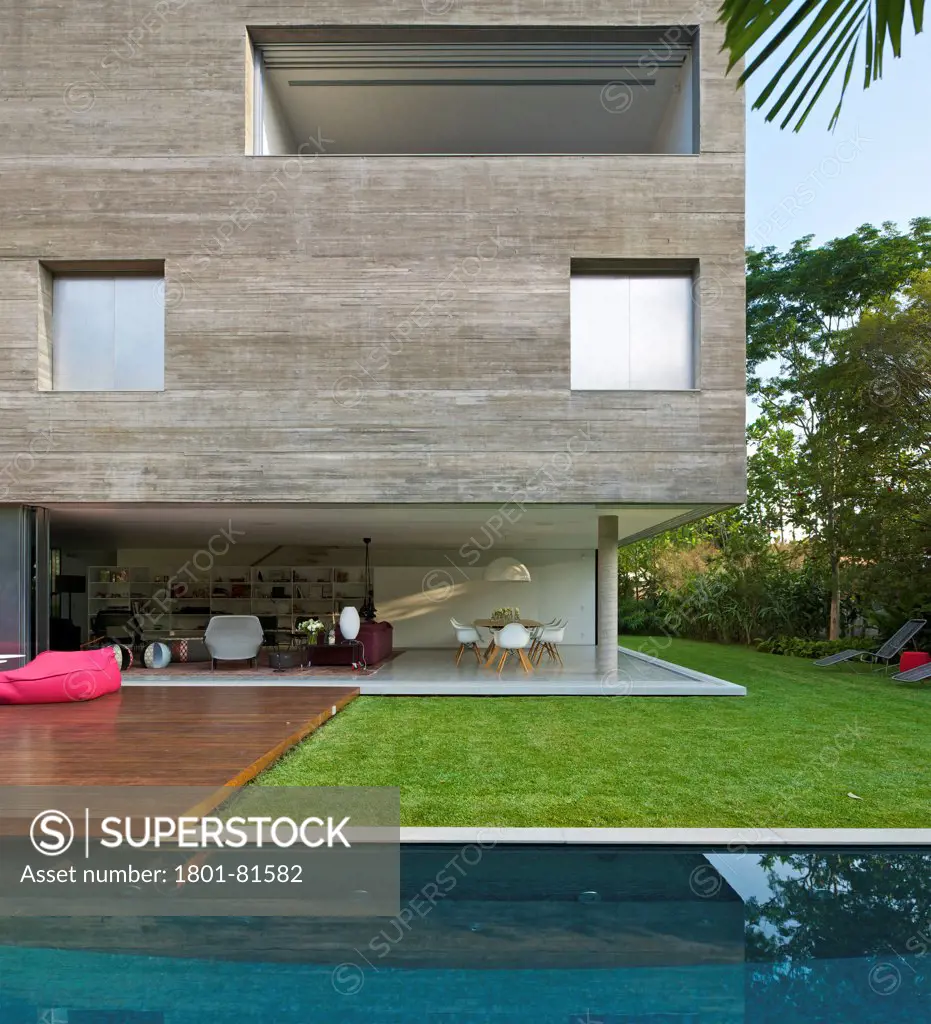 Casa Cubo, Sao Paulo, Brazil. Architect: Studio Mk27- Marcio Kogan, 2012. Partial Front Elevantion From Across The Pool.