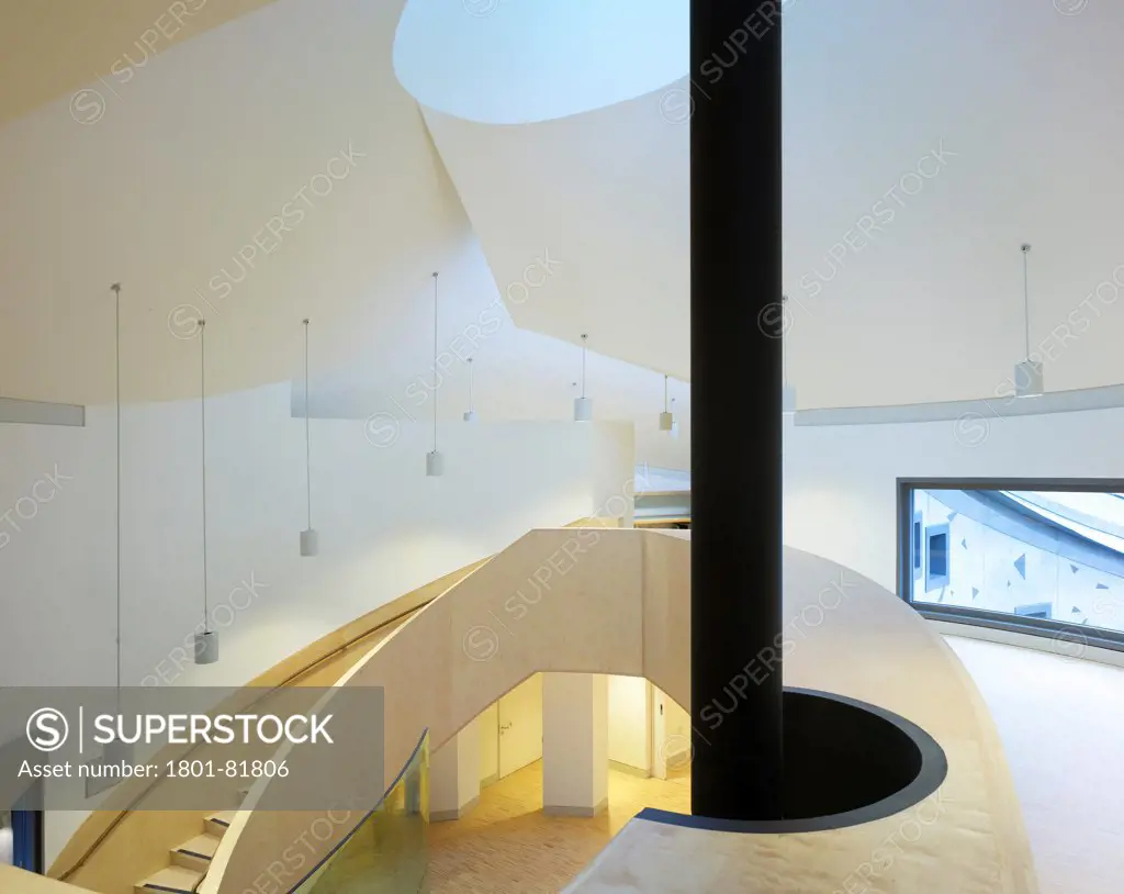 Maggie'S Cancer Caring Centre, South West Wales, Swansea, United Kingdom. Architect: Kisho Kurokawa Associates, Garbers & James, 2011. View Of The Stairs To The Mezzanine Gallery Showing Oculus Over The Entrance Hall And The Flue To A Suspended Fireplace.
