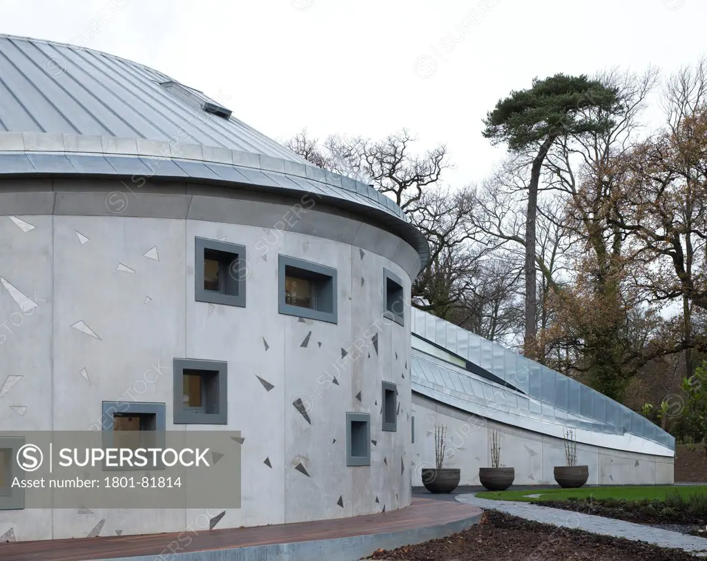 Maggie'S Cancer Caring Centre, South West Wales, Swansea, United Kingdom. Architect: Kisho Kurokawa Associates, Garbers & James, 2011. View Of The Central Facade With The Conical Roof And Titanium Plates Cast Into The Concrete Walls.
