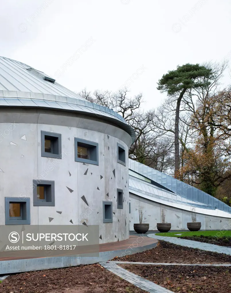 Maggie'S Cancer Caring Centre, South West Wales, Swansea, United Kingdom. Architect: Kisho Kurokawa Associates, Garbers & James, 2011. View Of The Central Facade With The Conical Roof And Titanium Plates Cast Into The Concrete Walls.
