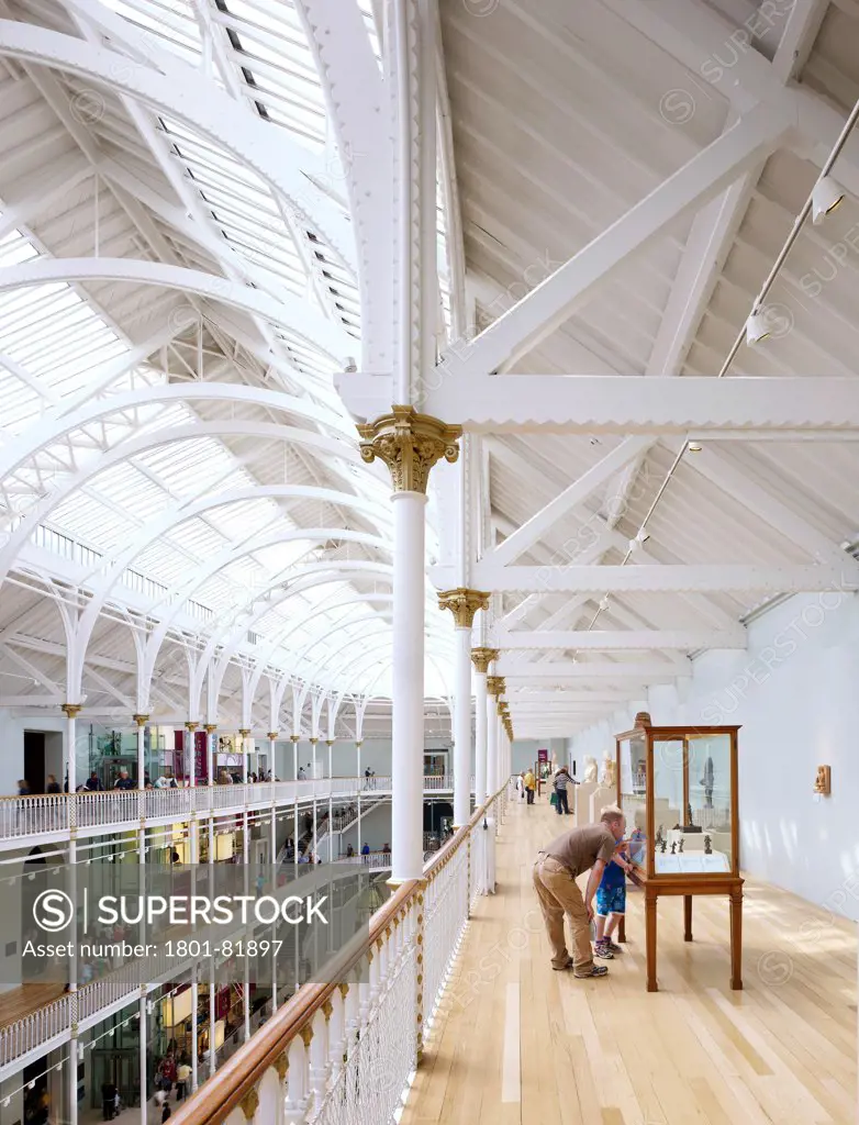 National Museum Of Scotland Redevelopment, City Of Edinburgh, United Kingdom. Architect: Gareth Hoskins Architects, 2011. View Of The Top Floor Of The Grand Gallery With Visitors, Showing The Vaulted Ceiling And Cast Iron Columns.