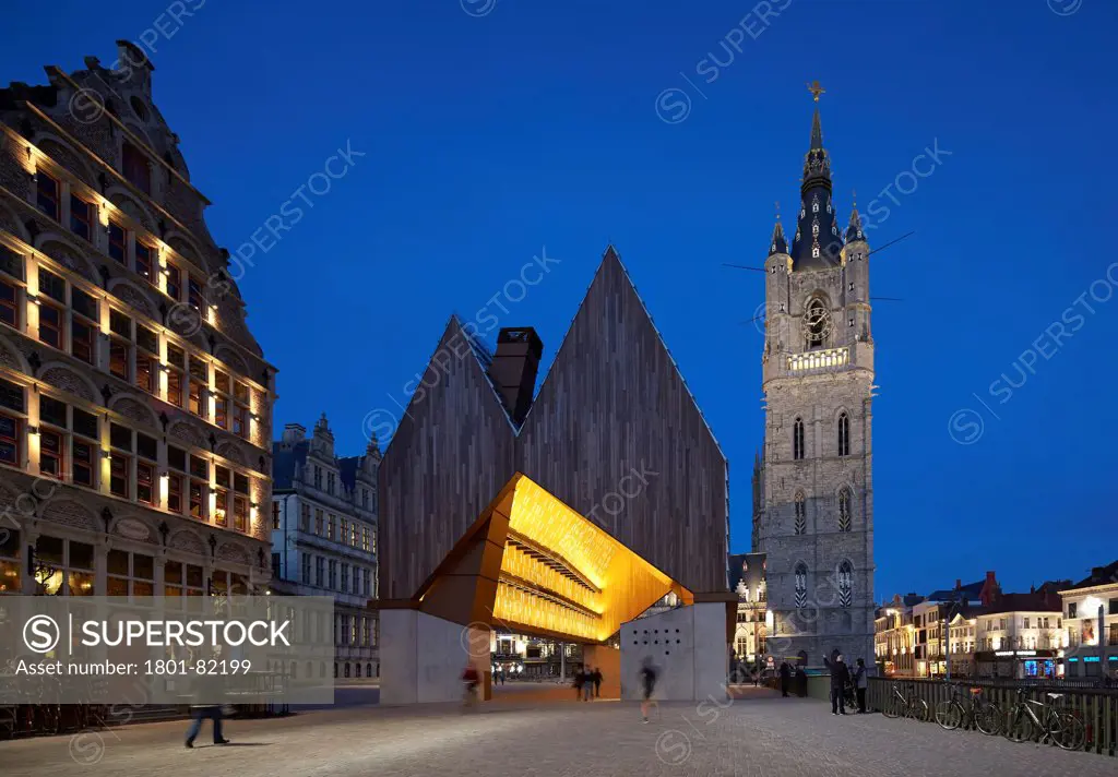 Ghent Market Hall, Ghent, Belgium. Architect: Robbrecht and Daem + Marie-Jose Van Hee, 2013. Market Hall in context with Ghent's great belfry.