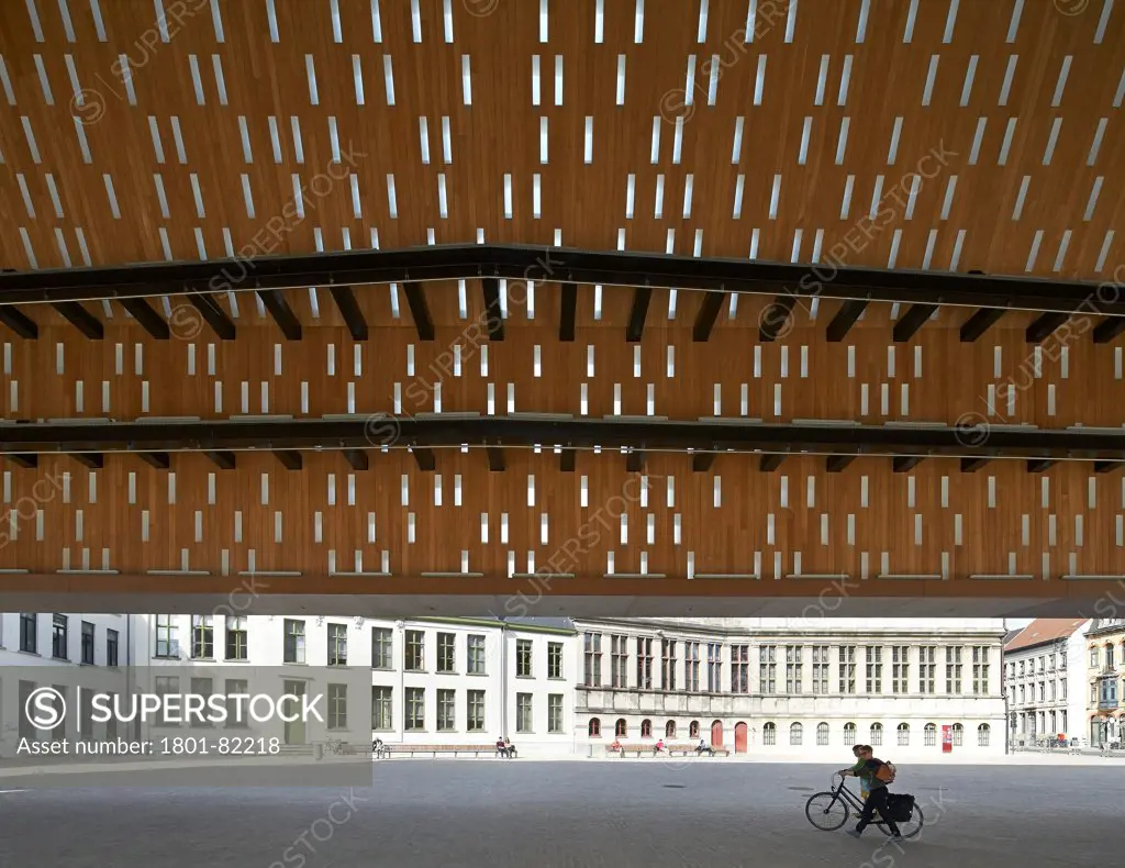 Ghent Market Hall, Ghent, Belgium. Architect: Robbrecht and Daem + Marie-Jose Van Hee, 2013. Underside of roof structure in juxtaposition with urban square.